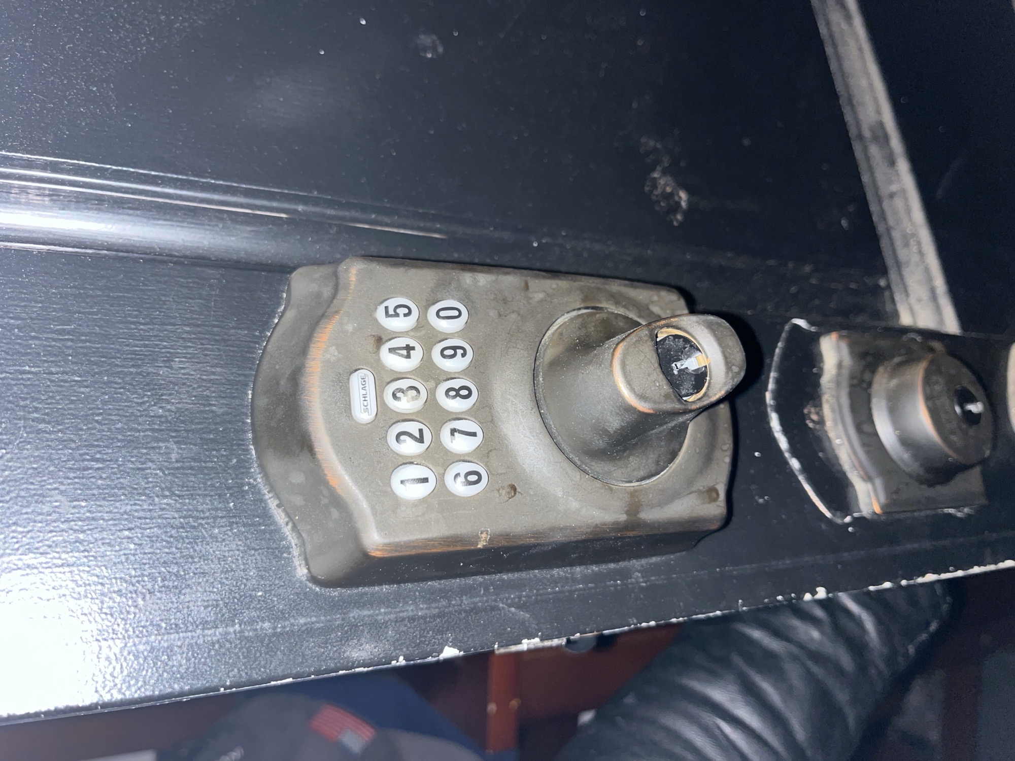 Rekeying a Schlage keypad deadbolt on a black door