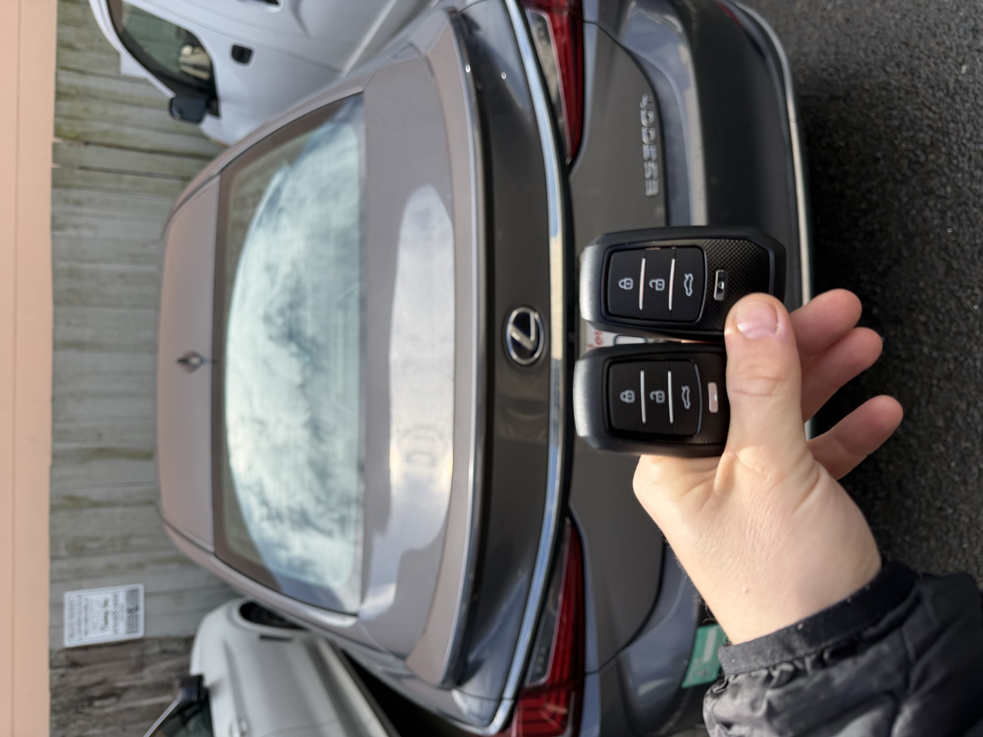 Two replacement key fobs for a gray Lexus ES sedan