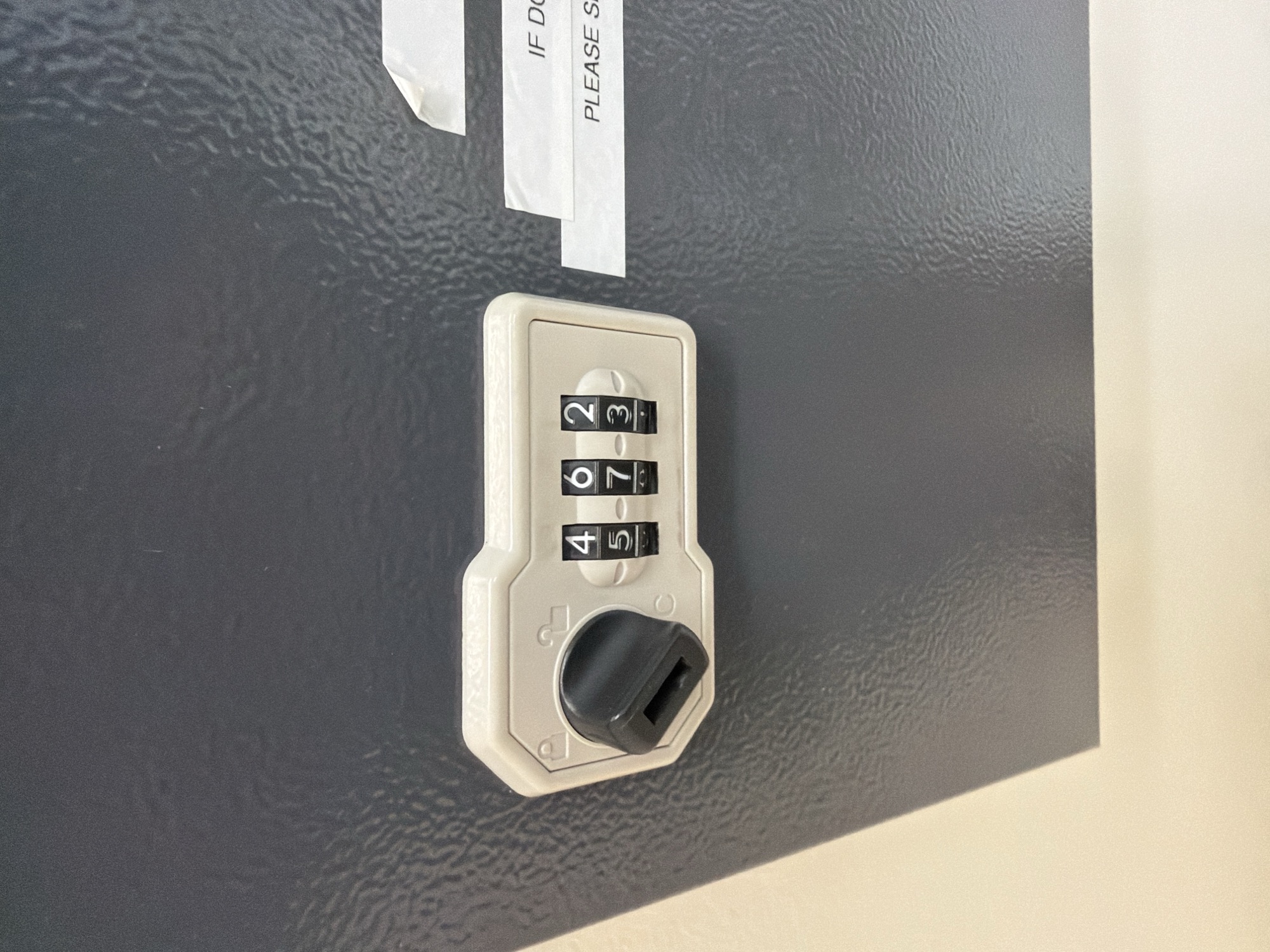 Combination push-button lock on a gray commercial door