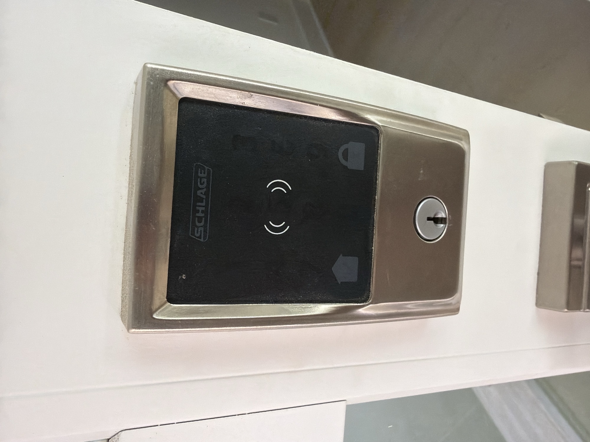 Schlage keyless touchpad deadbolt with keyhole override on a white door