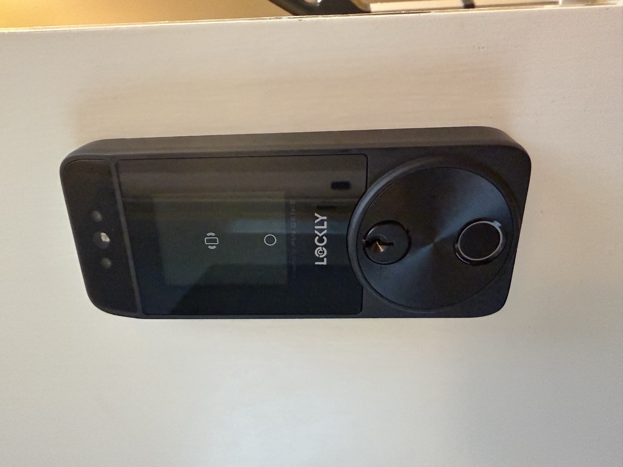 Lockly smart deadbolt with touchscreen keypad and key override on a door