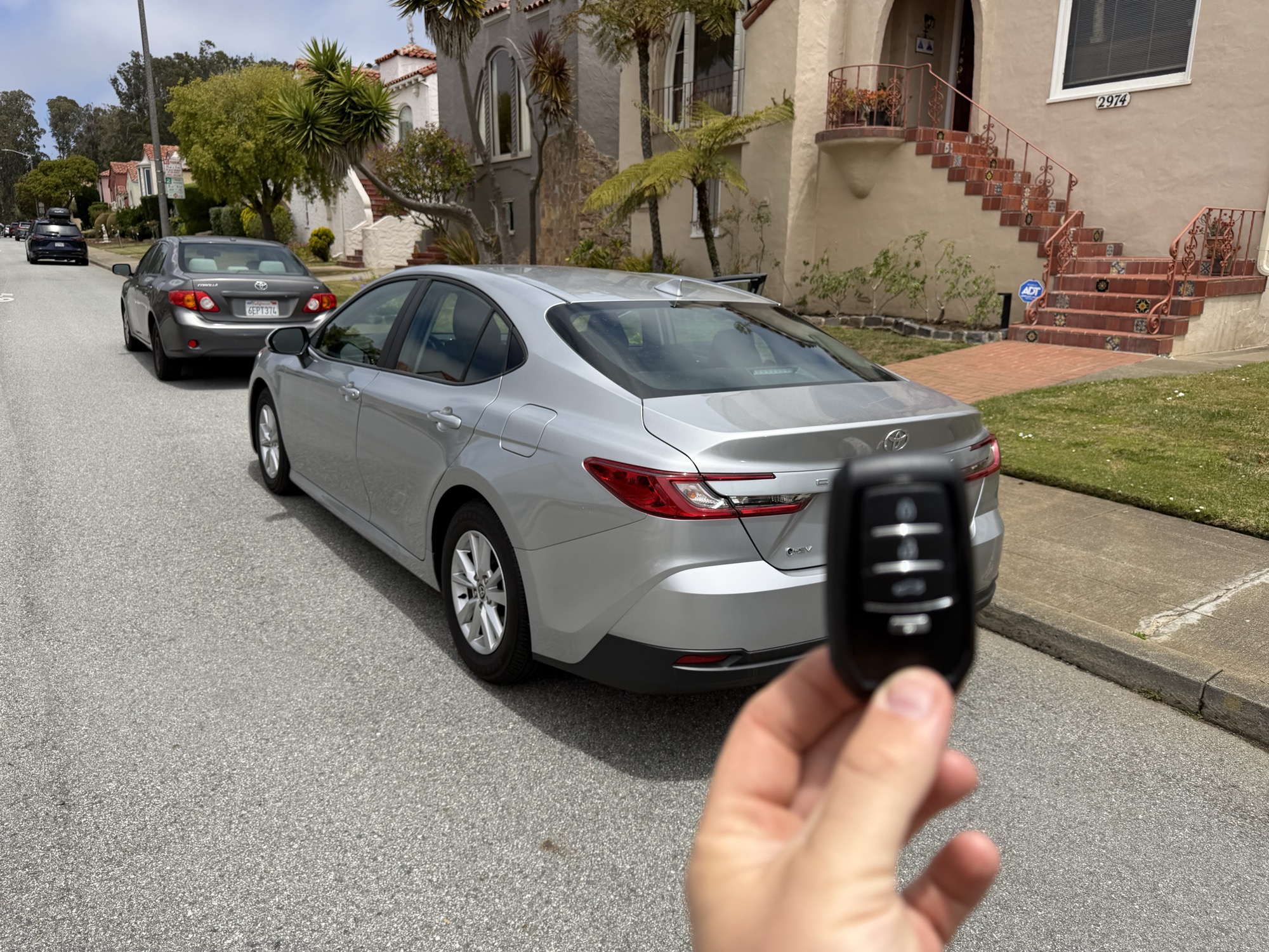 Silver Toyota Camry parked on a residential street with replacement key fob
