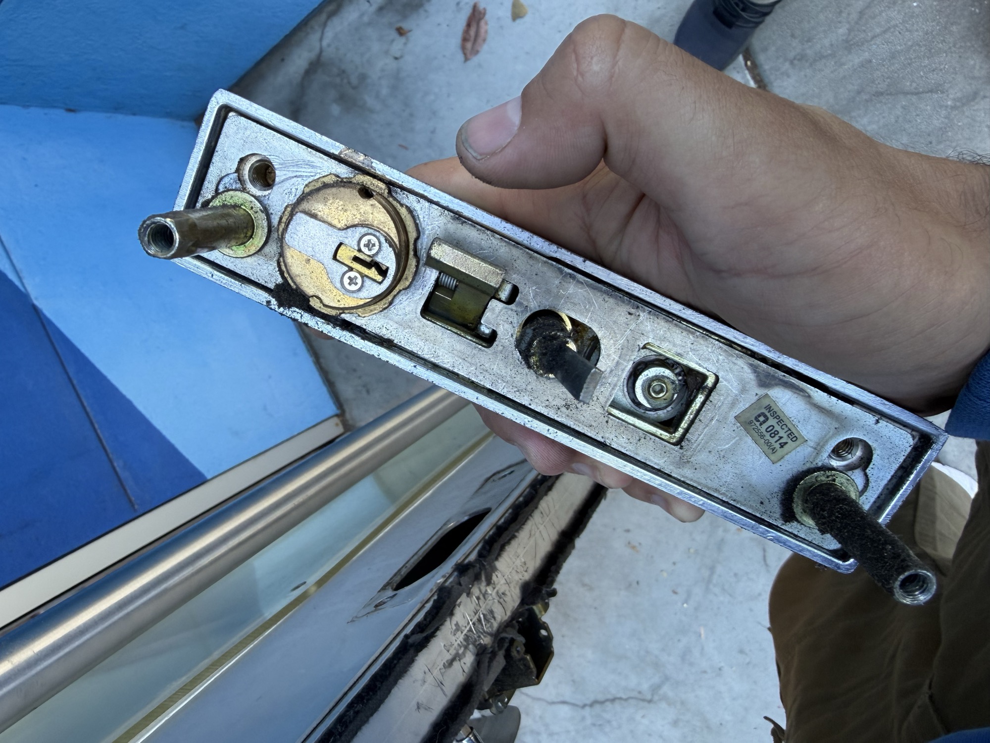 Mortise lock mechanism removed from a commercial glass door for rekeying