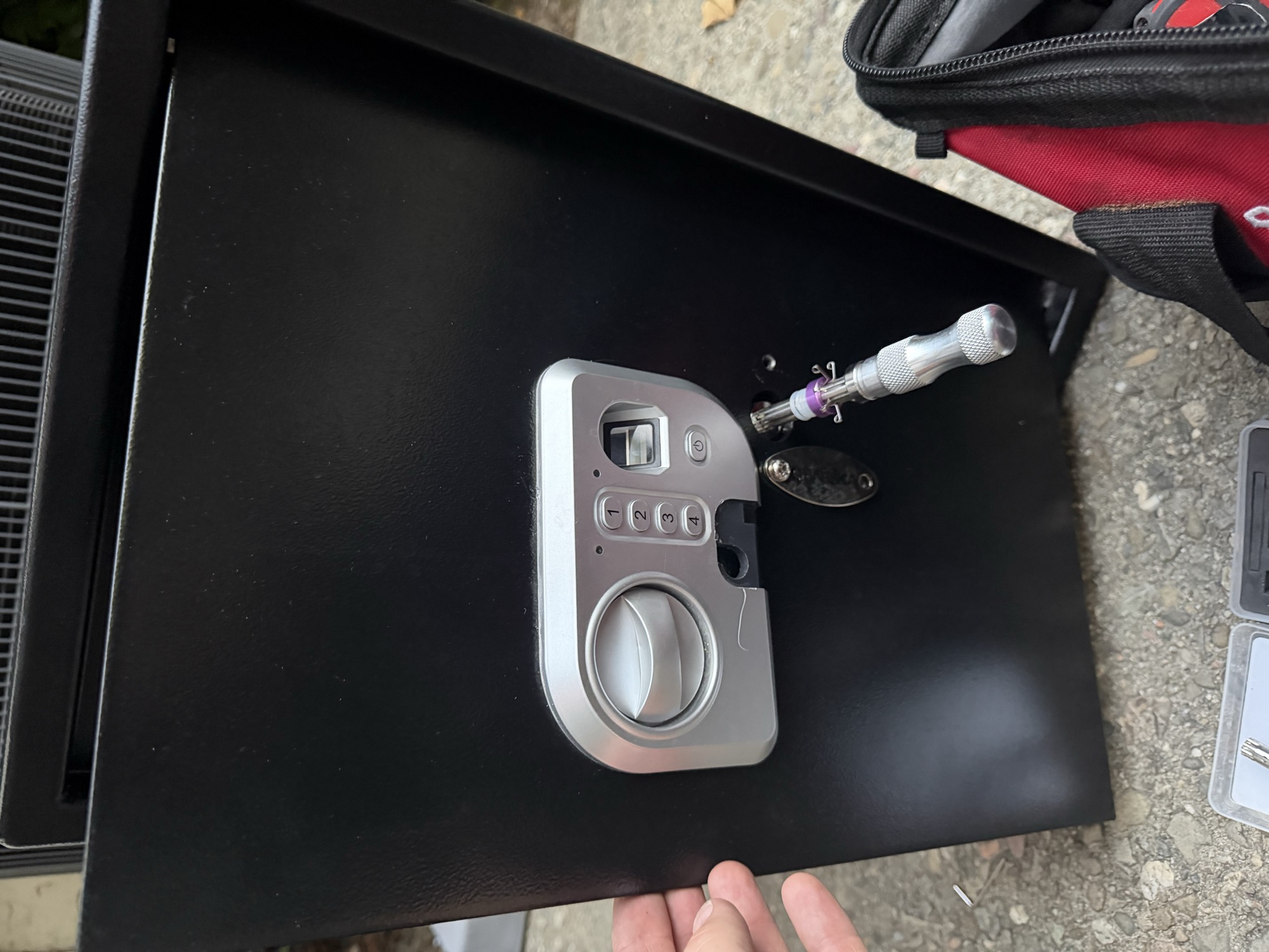 Bypassing a small electronic keypad safe lock with a pick and extractor tool