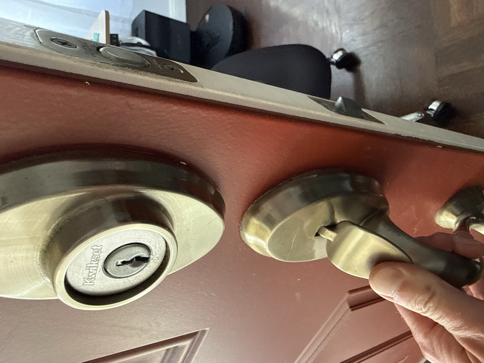 Kwikset deadbolt and door lever lock set on a wood front door