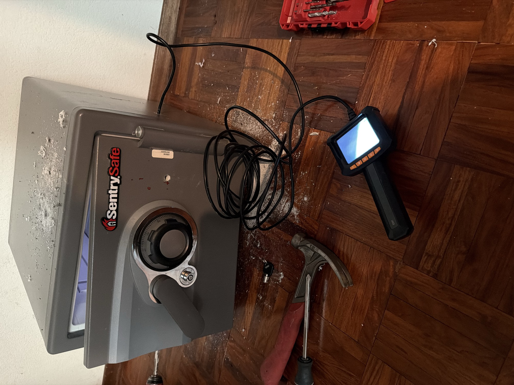 Opened SentrySafe fire safe with borescope camera and tools used to access it